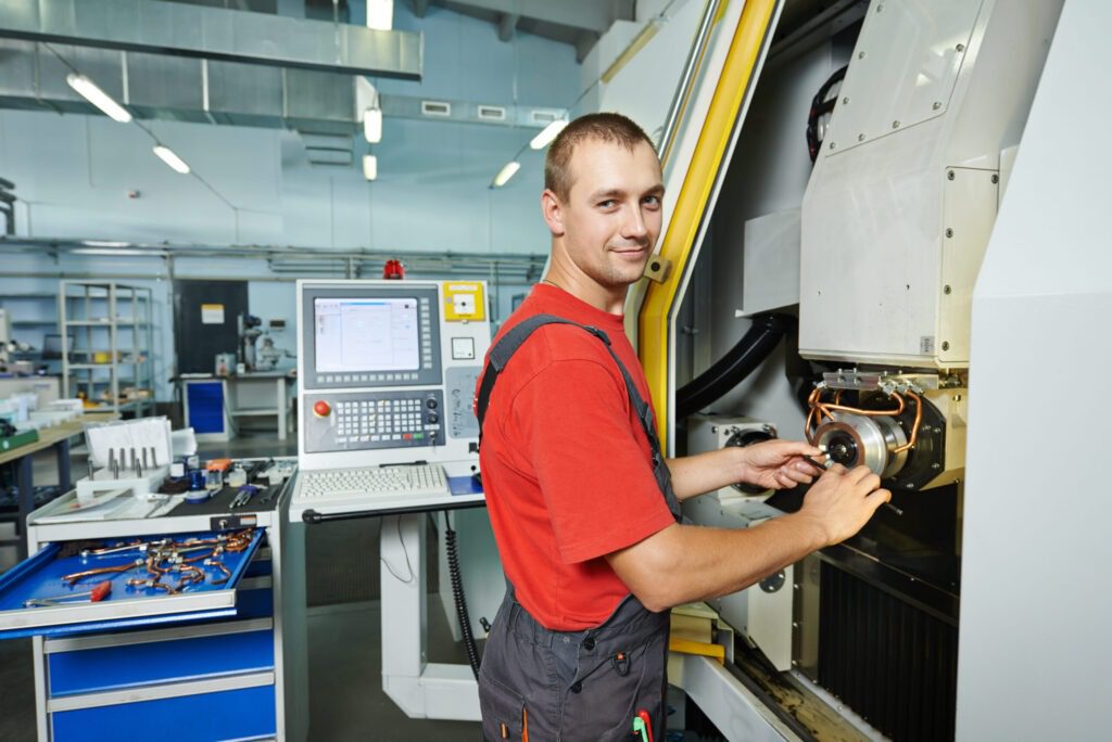 manufacture worker operating metal machining center at factory shop